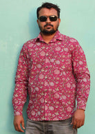 Man wears cotton long sleeve Indian floral print on a cranberry colour base shirt