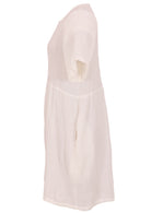 Side mannequin photo of natural white double cotton short sleeve relaxed fit dress with side pockets