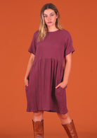 Model wearing 100% double cotton dress with round neckline and pockets 
in plum jam colour