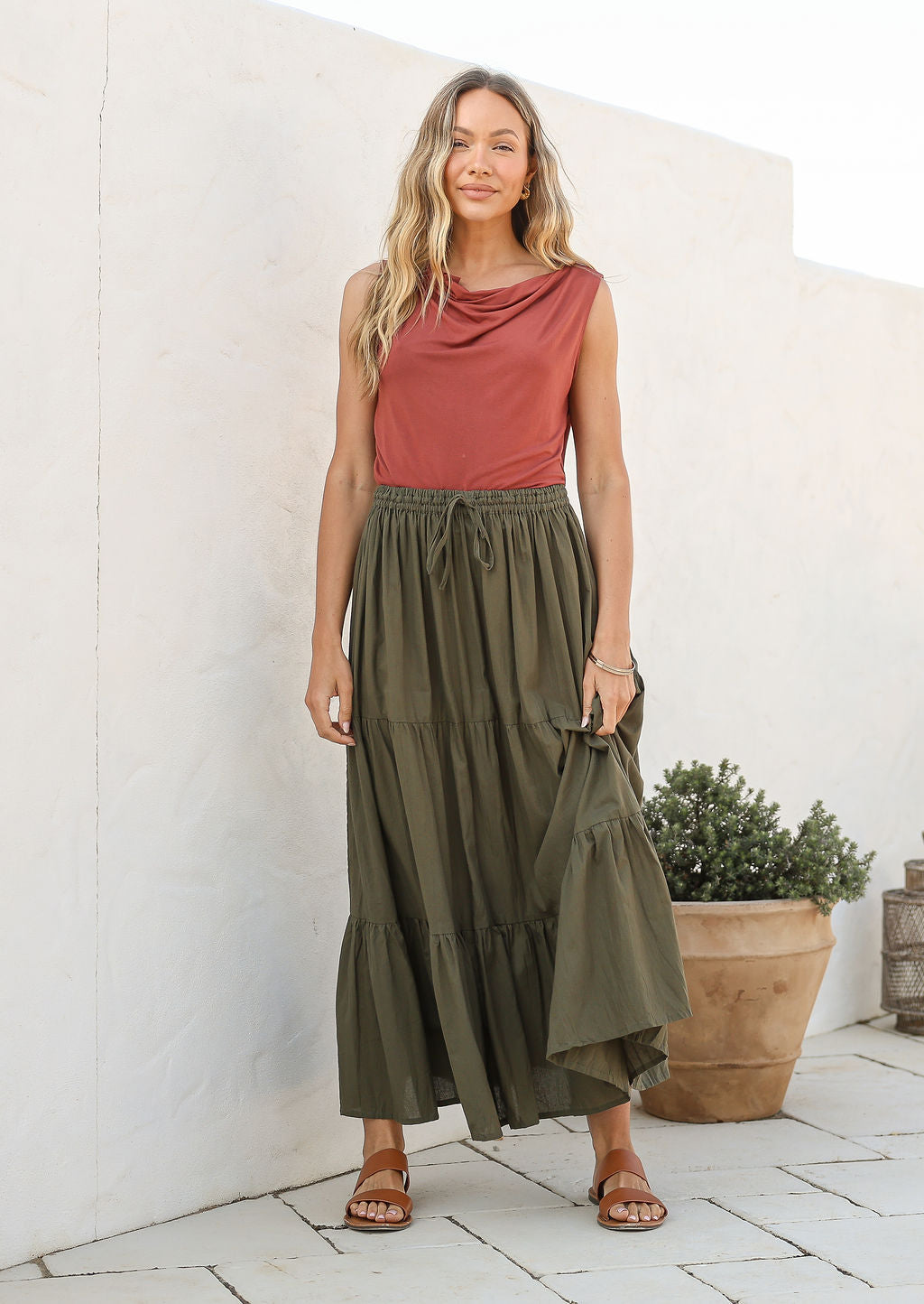 Model wearing a 100% cotton skirt in plain olive green shade paired with a pink top