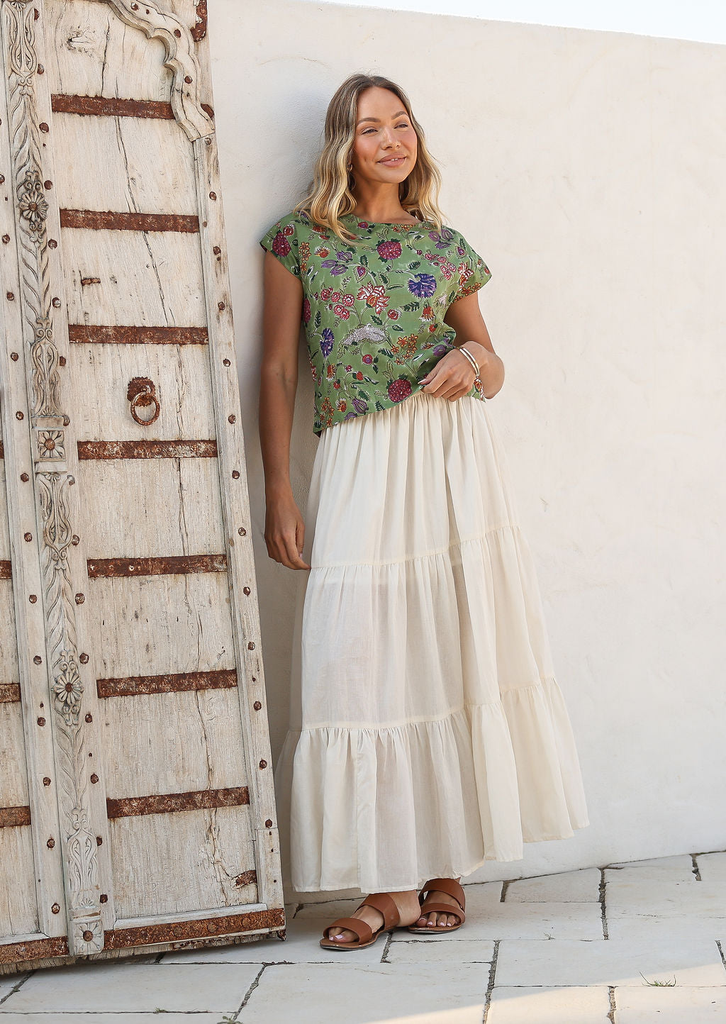 Model wearing a 100% cotton skirt in plain white colour paired with a green floral top