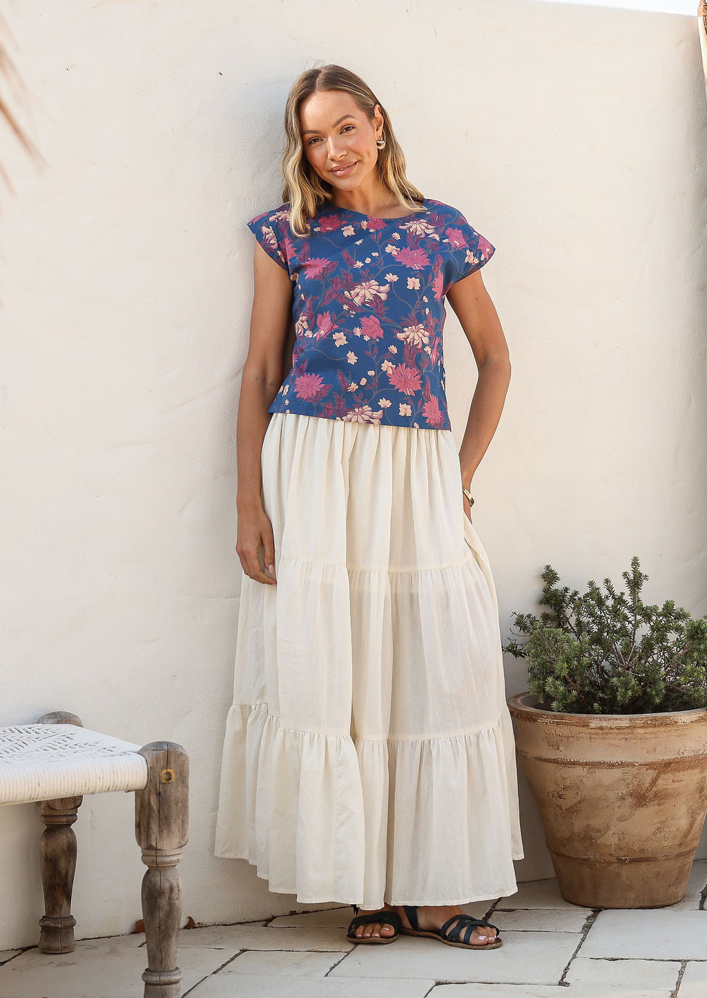 Model wearing a plain white cotton skirt with elasticated and drawstring waistband.