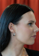 woman wearing medium sized silver hoop earrings Sterling Silver