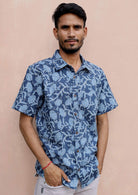 Man wears short sleeve cotton relaxed fit button through shirt in Indian inspired blue floral print