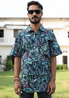 Man wears relaxed fit cotton short sleeve shirt with collar and one pocket