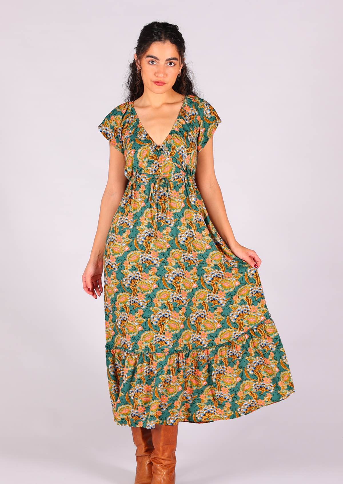 Model holding skirting of 100 percent rayon maxi dress with elasticised cross-over bodice