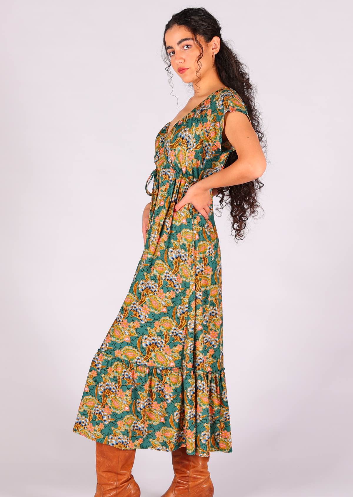 Model with hand on hip wearing 100 percent rayon maxi dress with shoestring drawstring