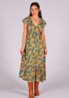 Model standing and wearing 100 percent rayon maxi dress with butterfly
sleeves and v-neck