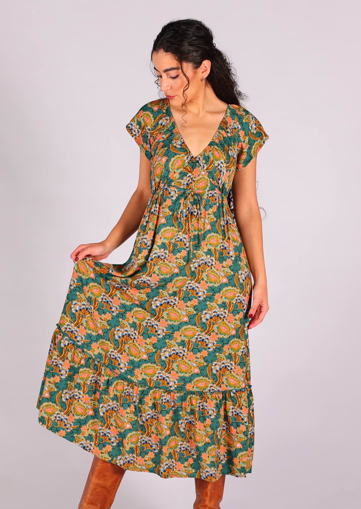 Model wearing 100 percent rayon maxi dress with short sleeves and drawstring waist