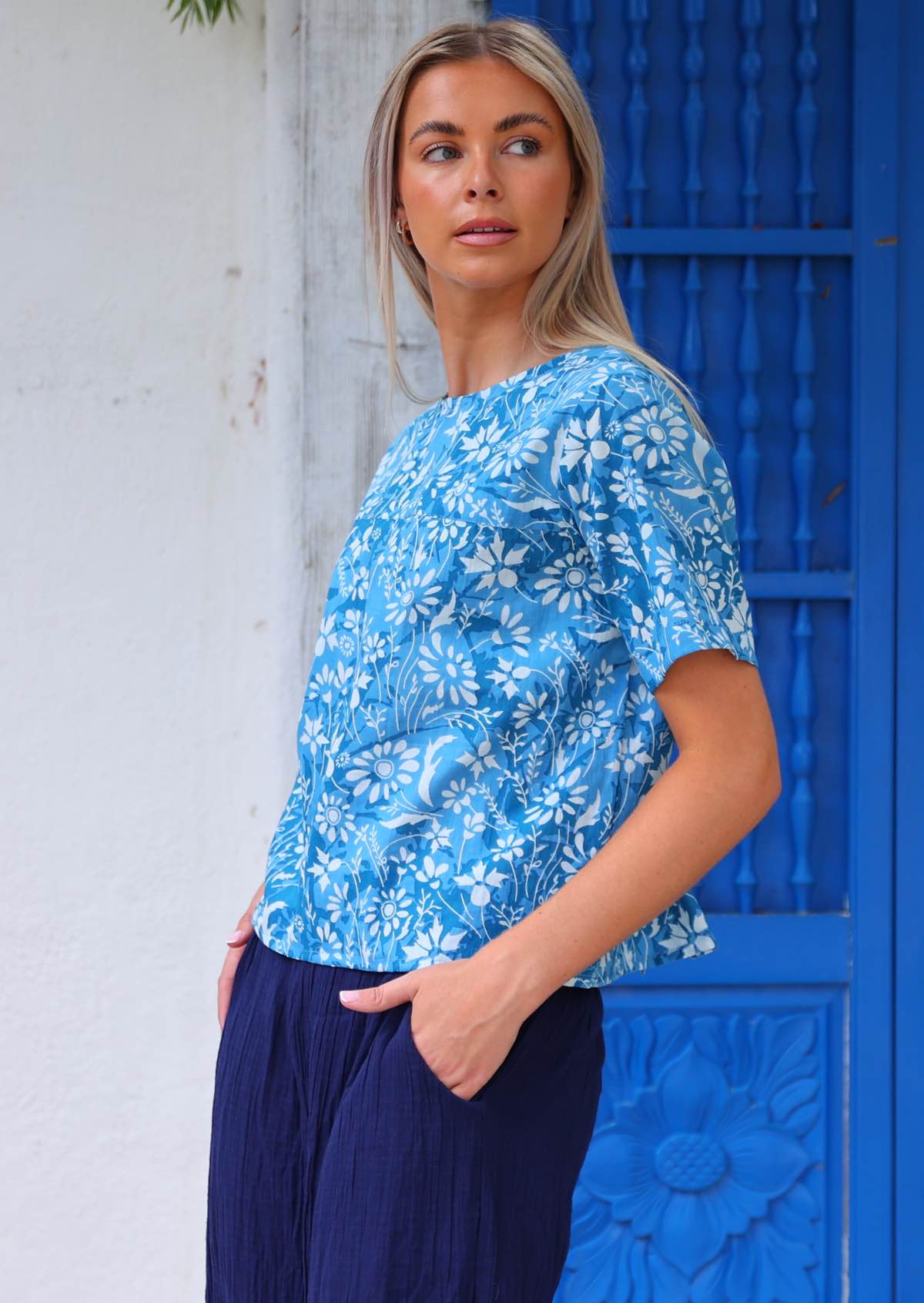 100% cotton blue floral blouse on woman with blonde hair worn with dark blue cotton pants