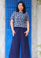 Model wearing floral navy blue boxy blouse 100 percent cotton paired with navy blue wide legged pants