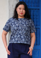 Model wearing floral navy blue boxy blouse 100 percent cotton short sleeve top