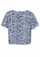 Back view of white based blue floral print cotton relaxed fit short sleeved top with decorative buttons through the centre back