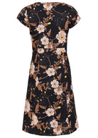 Back view of floral cotton dress with print featuring white blooms, tan foliage, and warm buttercup highlights on a black base.