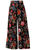 Back view of black based multi-colour floral velvet wide leg full length pants with a wide waistband