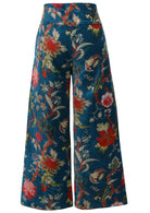 Back view of deep teal based multi-colour floral velvet wide leg full length pants with a wide waistband