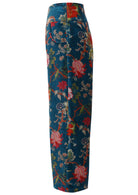 Side view of deep teal based multi-colour floral velvet wide leg full length pants with pockets and a side zip