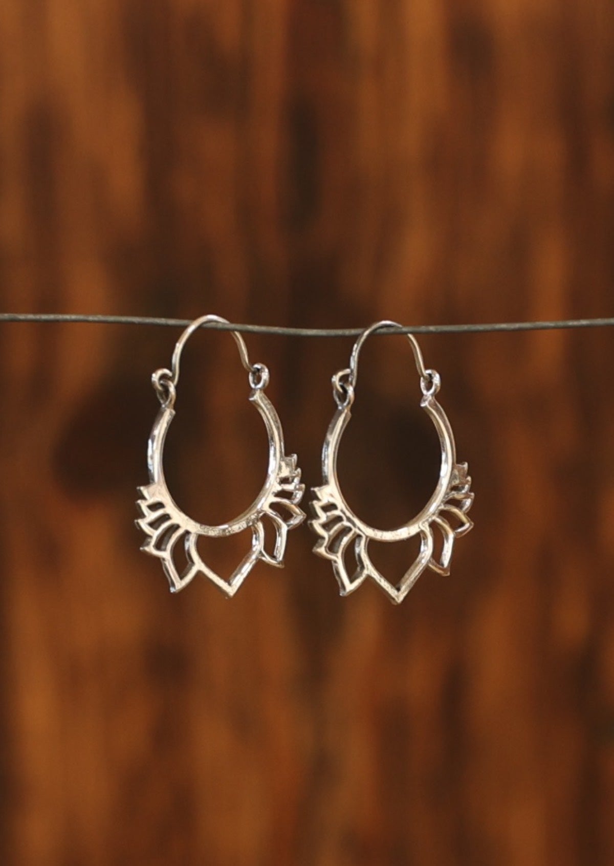 Silver lotus loop earrings secure with a wire hook