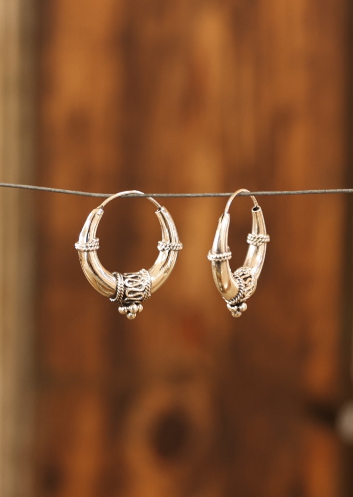 Sterling silver tapered hollow hoop earrings with silver rope and bead details