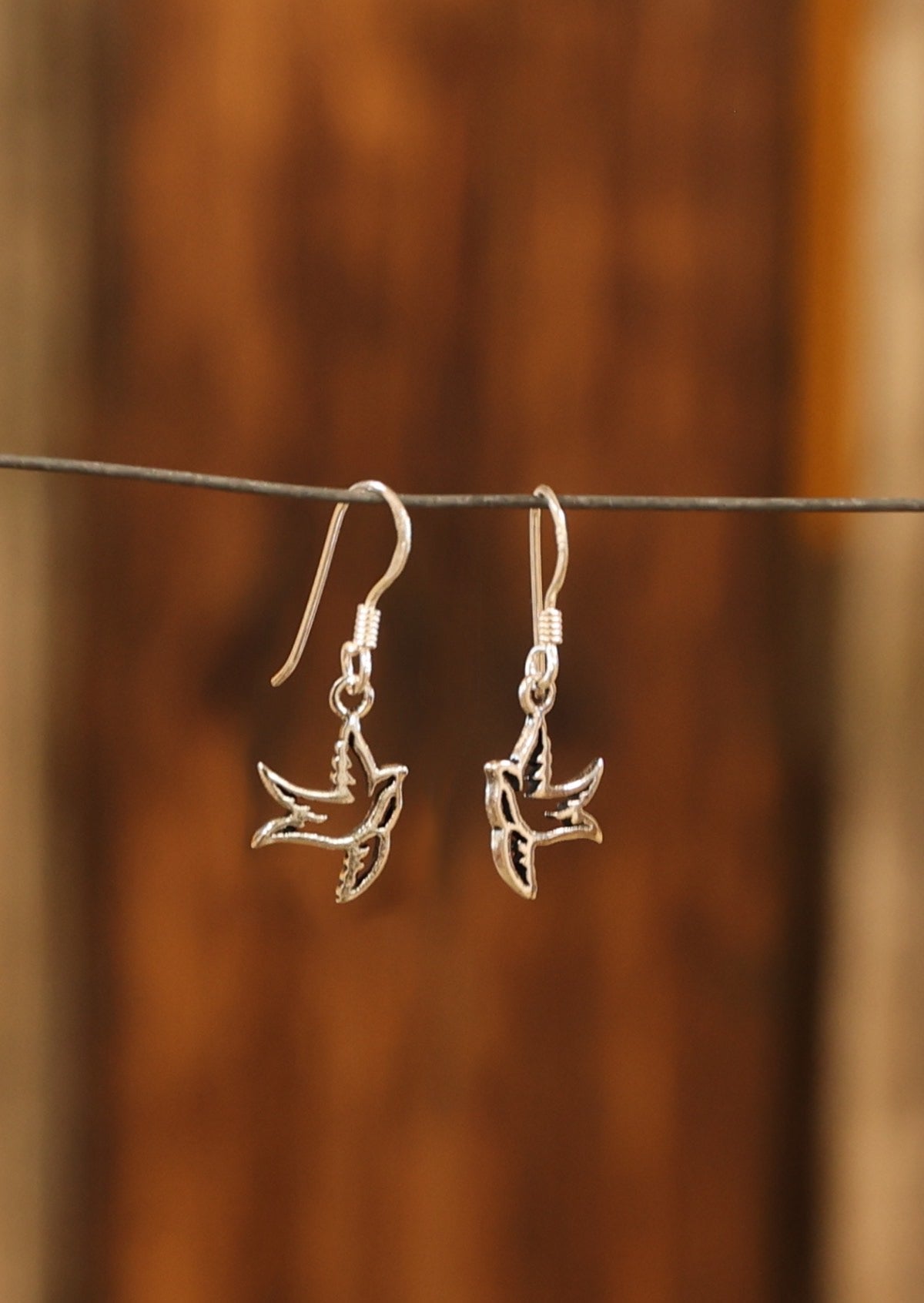 Bird cutout design crafted from sterling silver