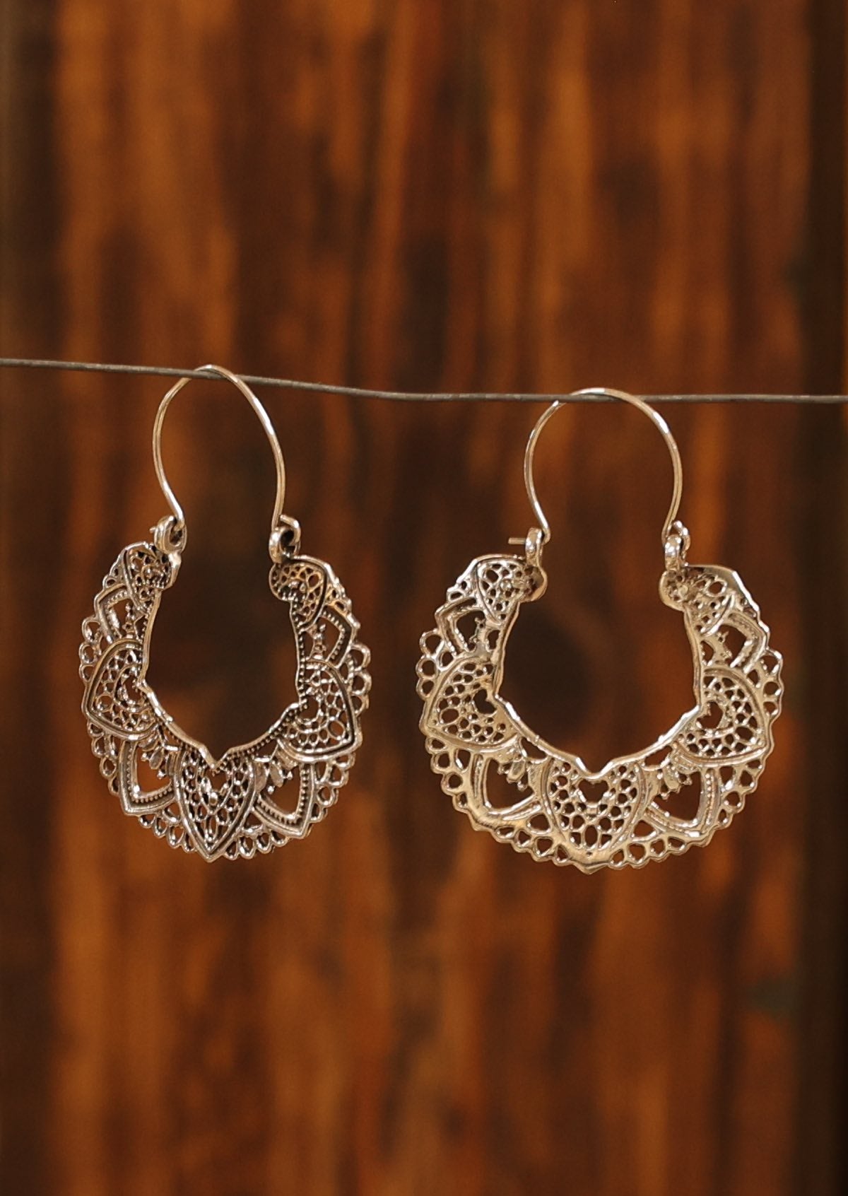 Sterling silver lace mandala earrings with etched detail on one side and secured with a wire hook