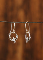 Sterling silver ring with beaded detail suspended from wire hook earrings