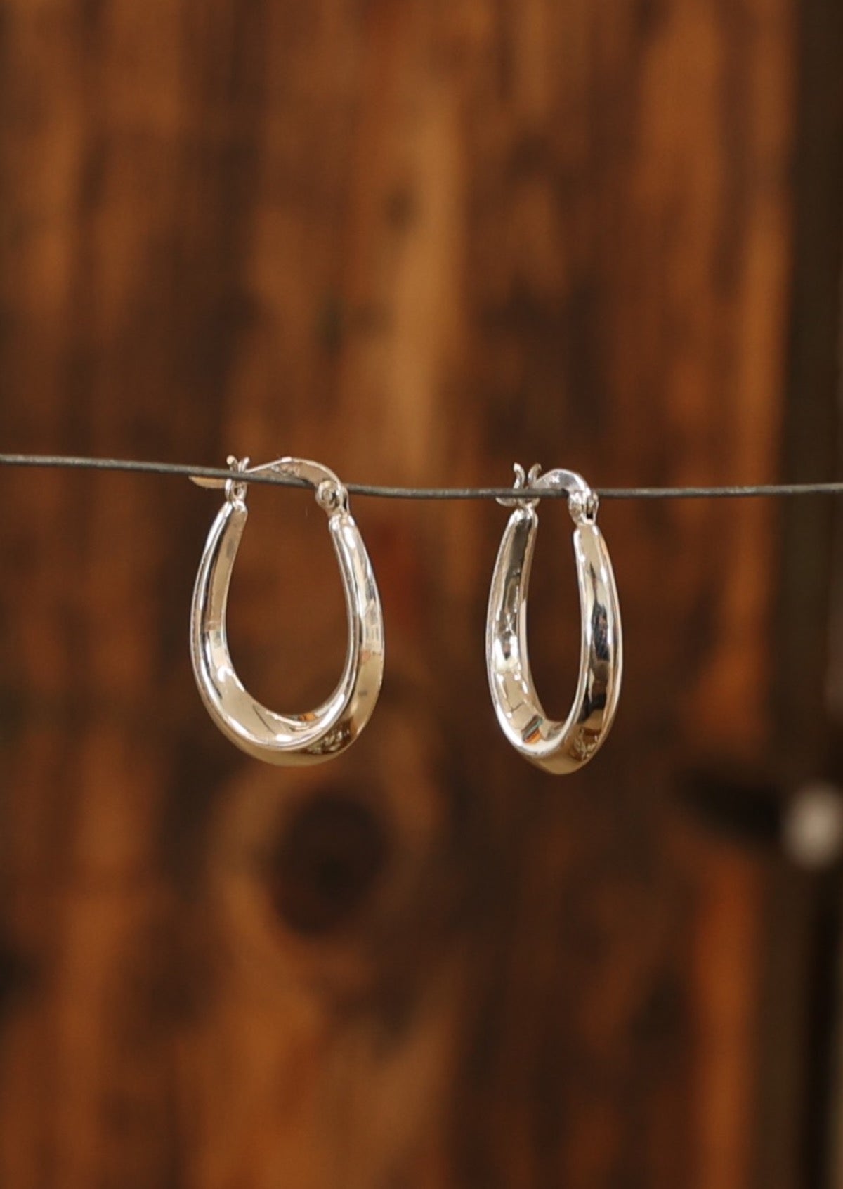 Approximately 19mm in width at base, and 27mm in length, with a maximum 5mm in thickness, these hoops are secured with a hinged clasp