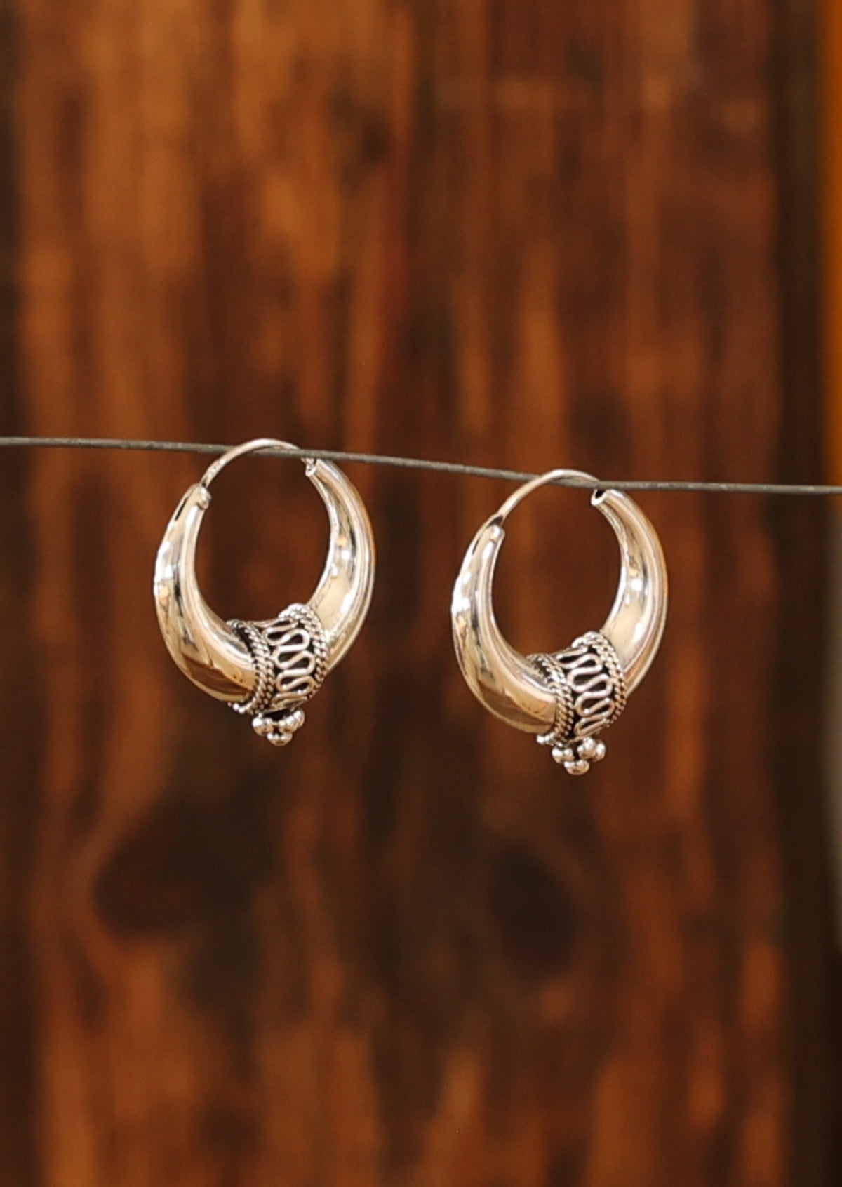 An abundance of detail at the base of the tapered earring creates interest