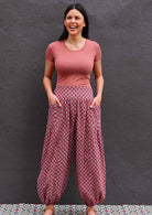 Model wearing 100 percent cotton harem pants with hands in pockets