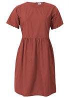 Loose fit 100% cotton above knee length rust coloured dress with short sleeves, pockets and high round neckline 