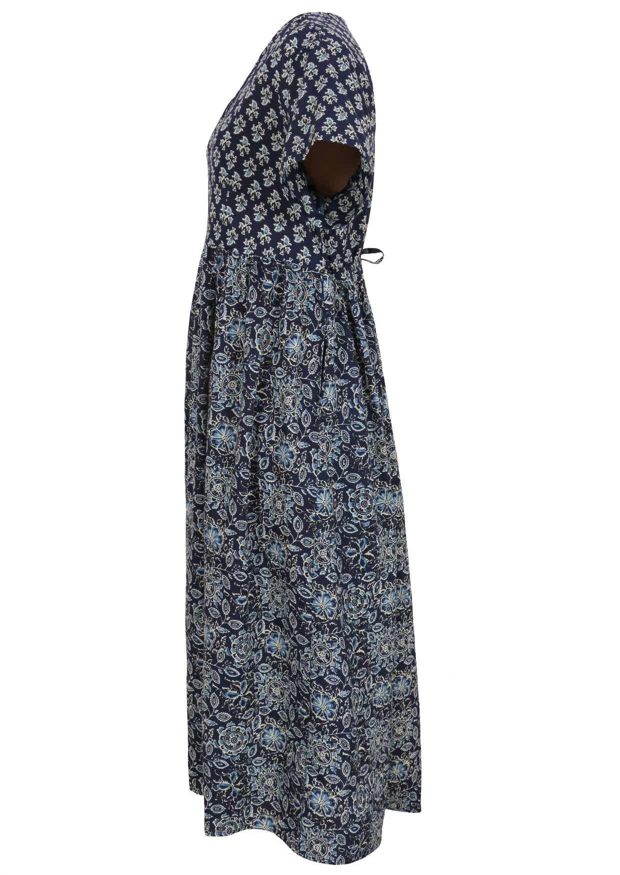 Side view of navy blue based floral print V-neck cotton dress with pockets.