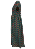 Green based motif in red, pink, green, and mustard floral print V-neck cotton dress with pockets.