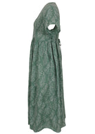 Side view of green based floral print V-neck cotton dress with pockets.