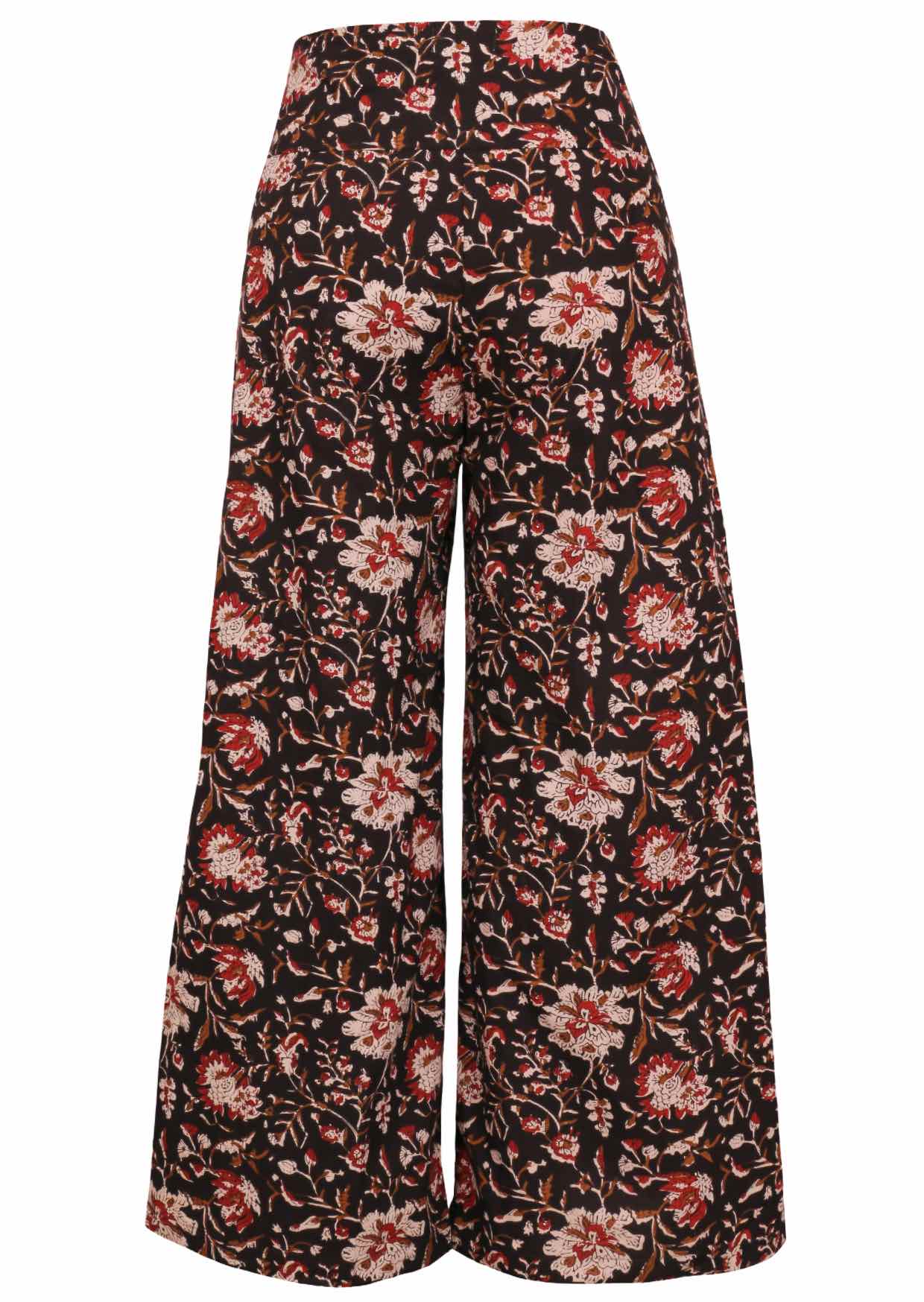 Back view of women's 100% cotton wide leg pant in black based floral print with side zip