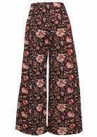 Back view of women's 100% cotton wide leg pant in black based floral print with side zip