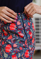 Model showcasing side zipper in the 100% cotton floral printed reversible skirt.