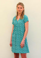 Model standing wearing 100 percent cotton aqua short sleeve beach dress