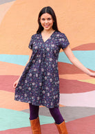 Model wearing short sleeve cotton dark purple tunic 