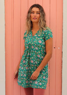 Model standing in front of pink door wearing 100 percent cotton short sleeve  tunic