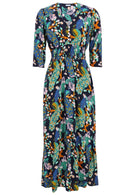 3/4 sleeved rayon maxi dress with buttoned bodice, V-neckline and a wide shirred waistband, in a floral and peacock print on a navy base