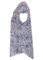 White based blue floral print cotton top on a white background.