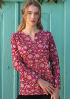 100% cotton cranberry based floral print long sleeve top with V cutout neckline.