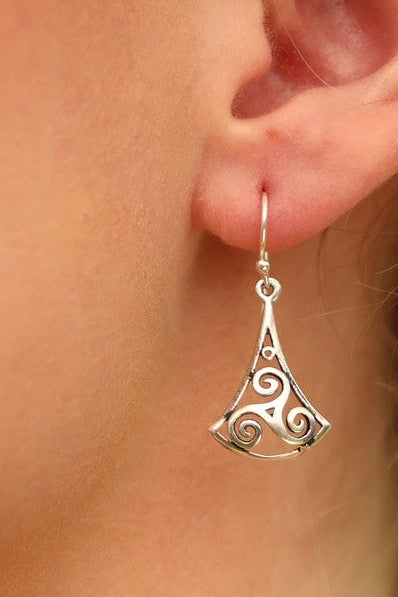 Model wears sterling silver swirly triangle hook earrings