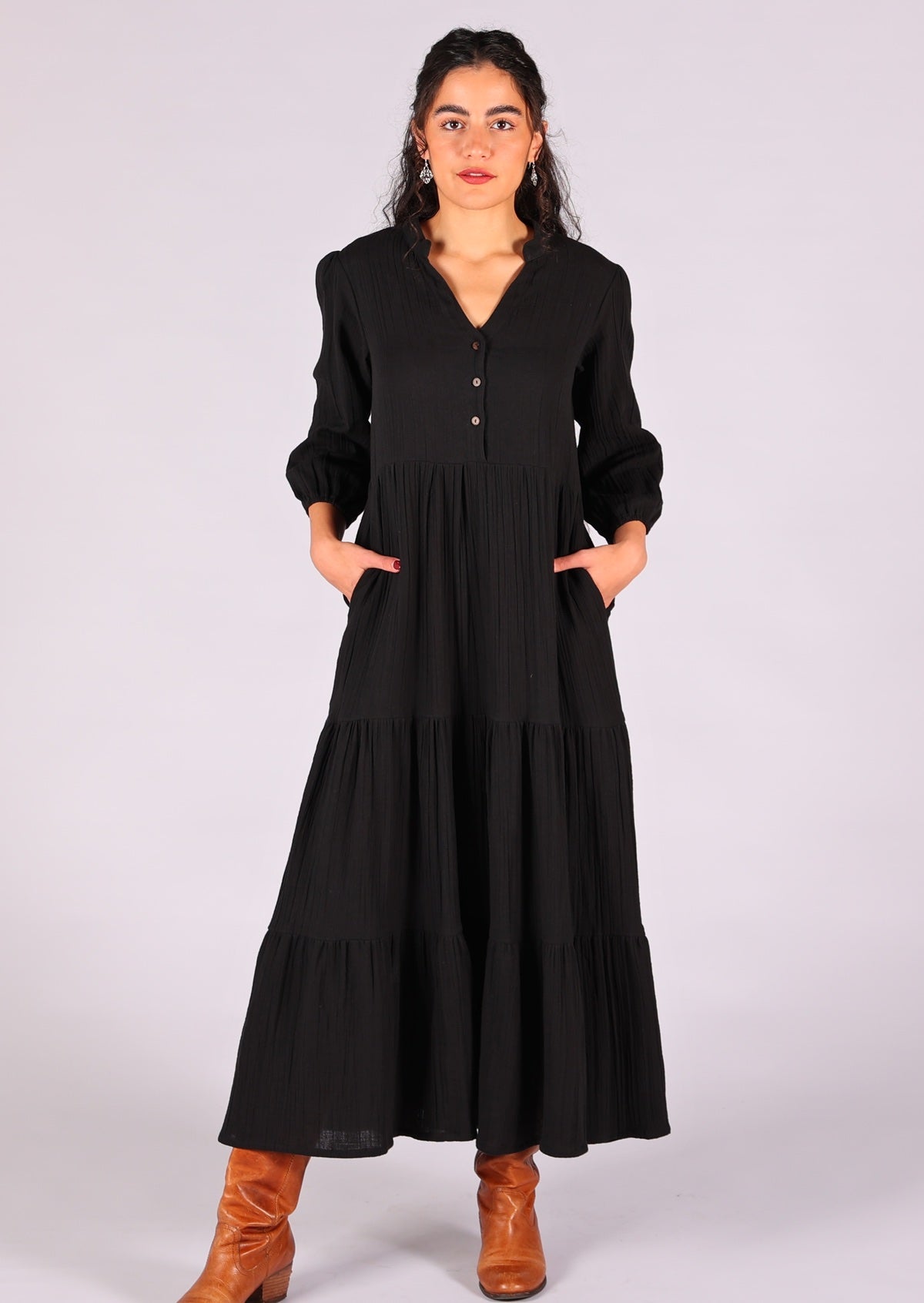 Model poses in double cotton tiered maxi dress with hidden side pockets