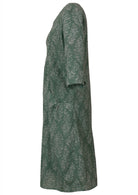 Side view of relaxed fit below knee length cotton dress with 3/4 sleeves, pockets and round neckline.
