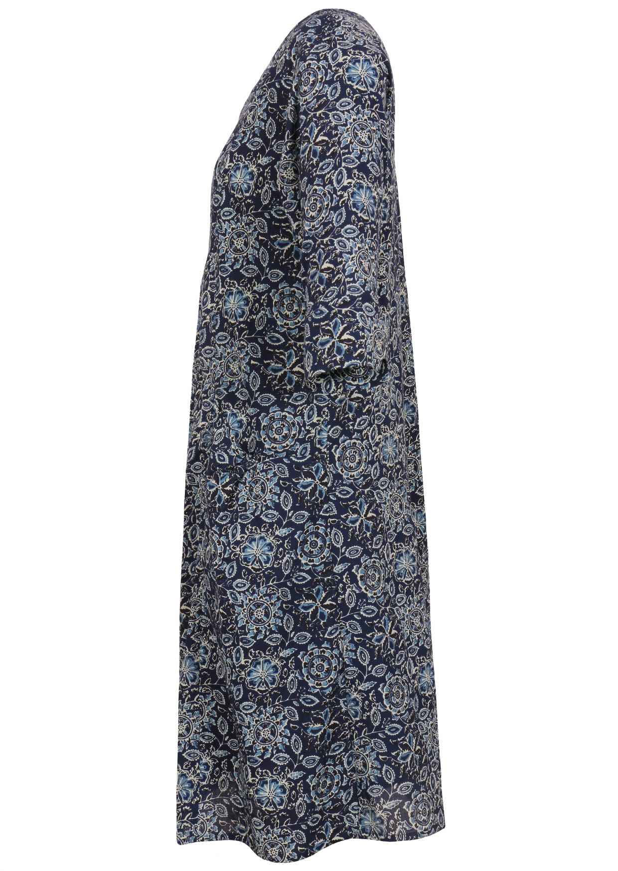 Side view of relaxed fit below knee length cotton dress with 3/4 sleeves, pockets and round neckline.