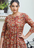 Close up image of model wearing loose fit dress with 3/4 sleeves, and sweet keyhole neckline.