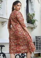 Model wears 100% cotton  knee length dress with hints of earthy floral tones.