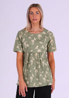 Model wears relaxed fit cotton short sleeve top with high round neckline and gathers under the bust