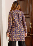 Model showcasing back of 100% cotton tunic with long sleeves, mandarin collar and small gathers at center of the back.